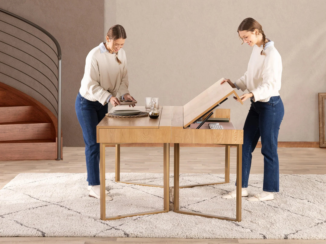 Two women assembling a wooden table in a room with a neutral color scheme.