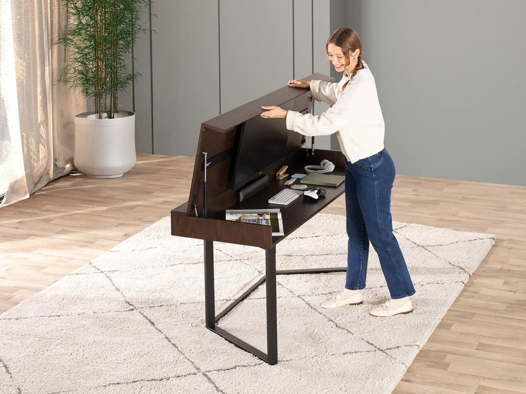 Woman interacting with a modern standing desk in a home office setting