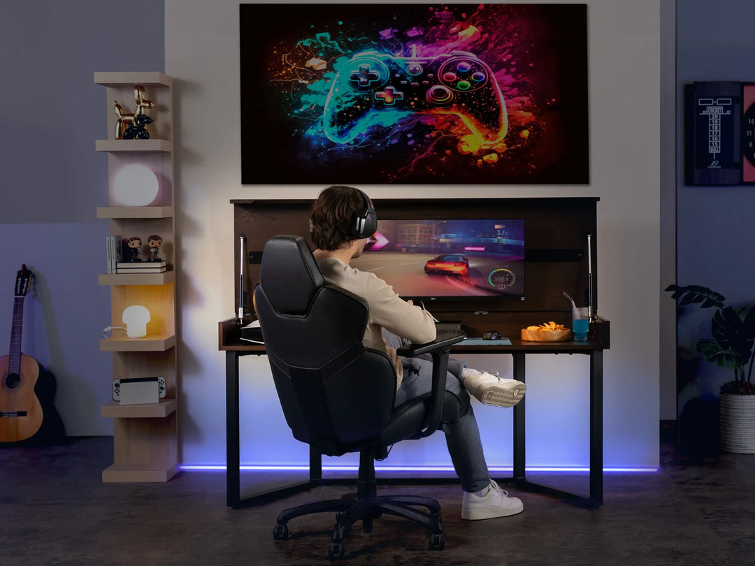 Person playing video games in a home setup with a large screen displaying colorful graphics.