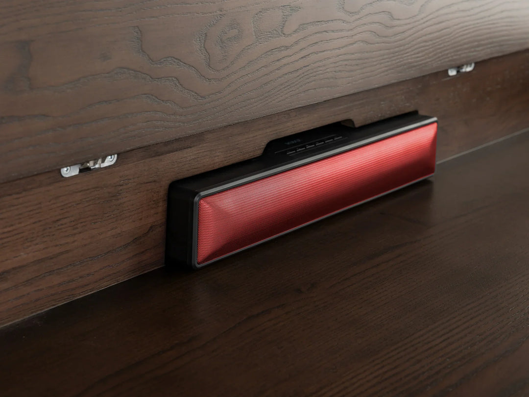 Red electronic device on a wooden surface