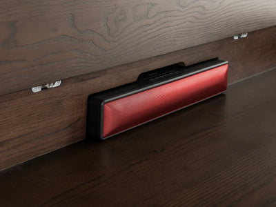 Red electronic device on a wooden surface