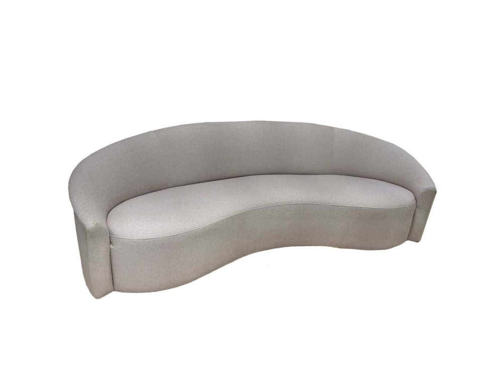 Curved gray sofa on a white background