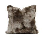 A square faux fur throw pillow in a mottled brown and gray colorway, shown against a plain white background 