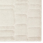 Textured beige rug with a subtle pattern on a white background