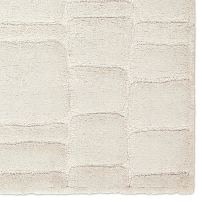 Textured beige rug with a subtle pattern on a white background