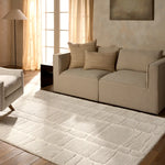 Living room with beige sofa, armchair, and textured rug.