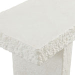 Close-up of a white textured console table on a white background