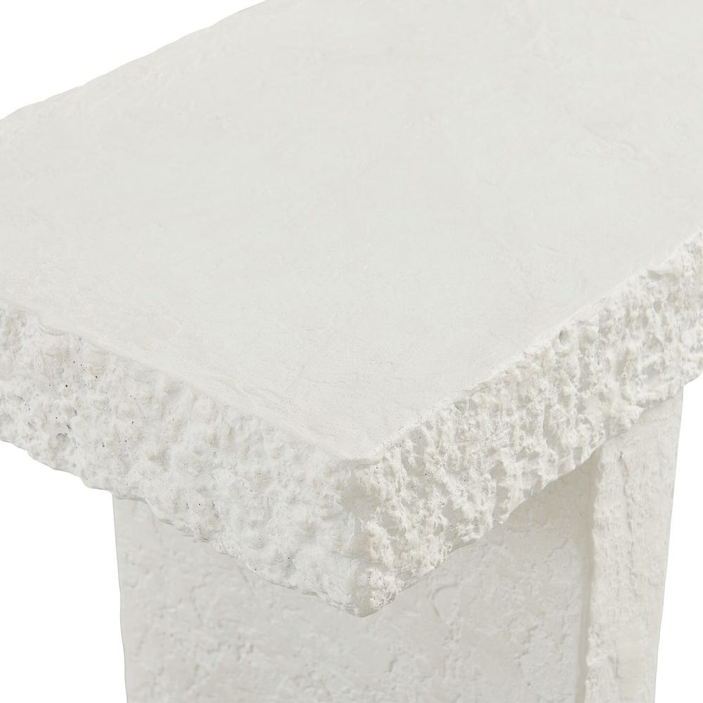 Close-up of a white textured console table on a white background