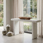White textured console table near windows