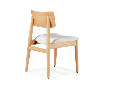 Wooden chair with a white cushion on a white background