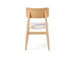 Wooden chair with a white cushion on a white background