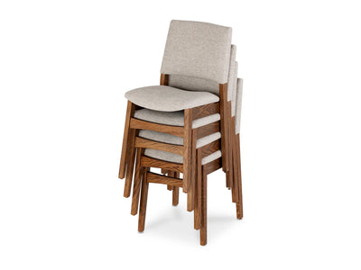 Stack of wooden chairs with gray cushioned seats on a white background