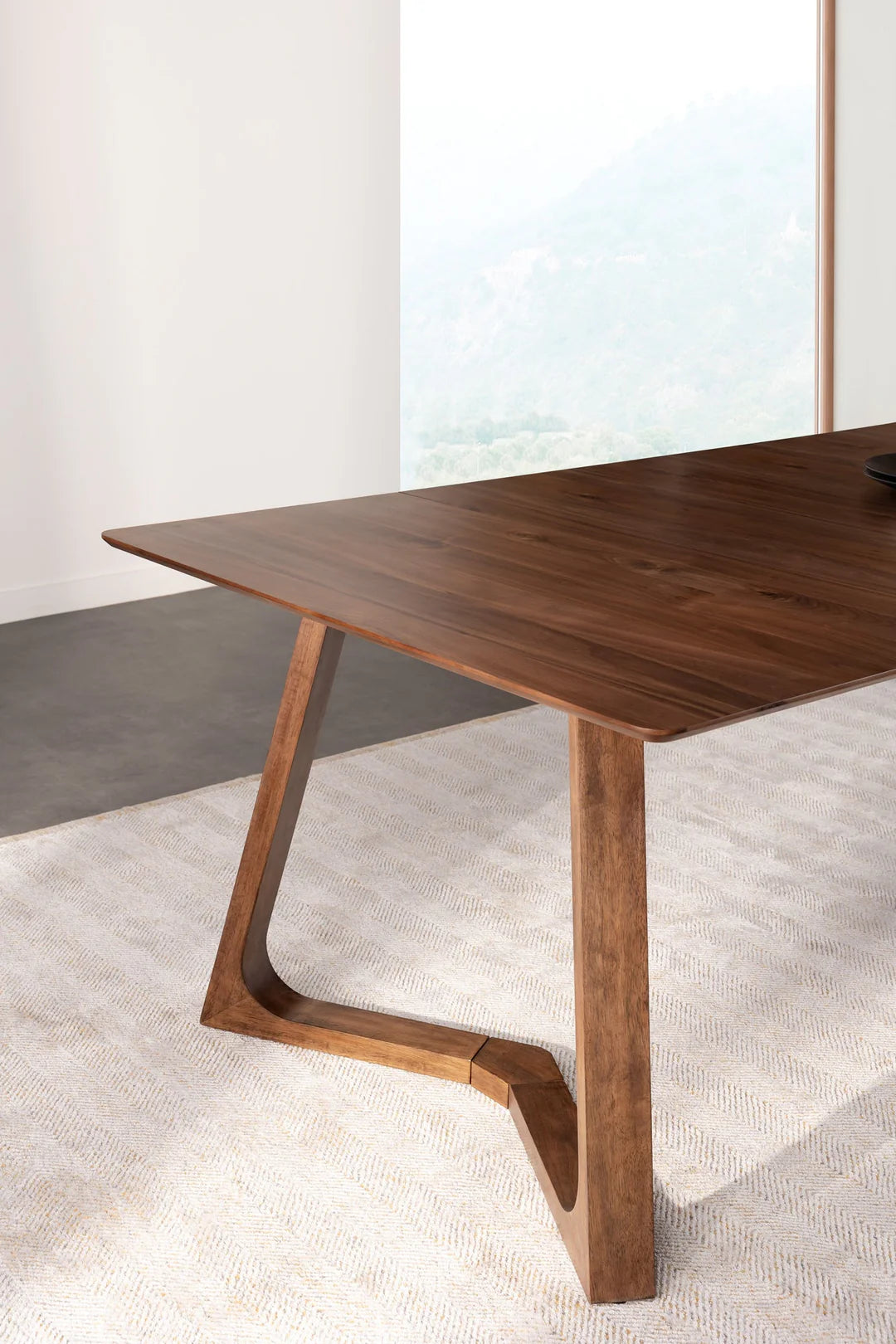 Wooden dining table with a modern design in a minimalistic setting