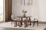 Dining room with wooden table, chairs, and bench on a light gray rug.