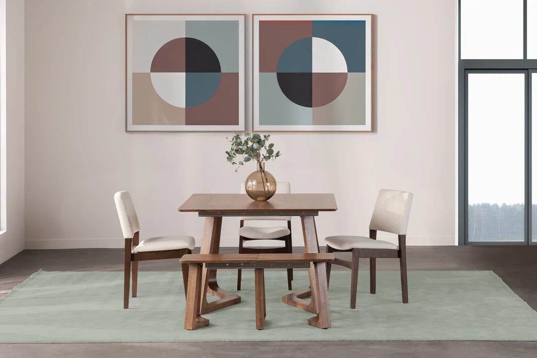 Dining room with wooden table and chairs, abstract art on the wall, and a vase with flowers.