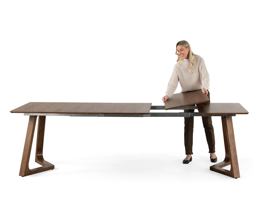 Woman assembling a wooden desk on a white background