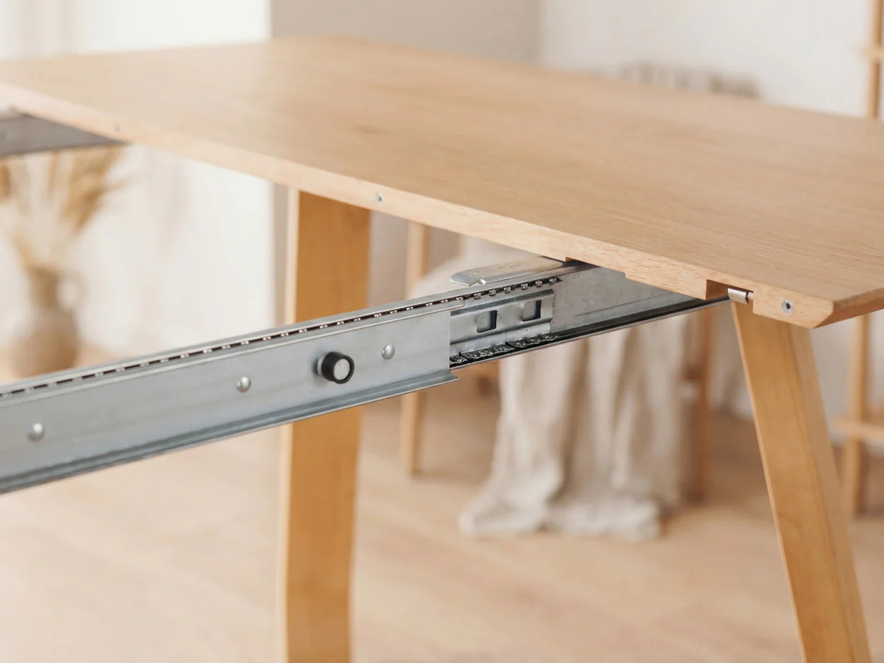 Wooden desk with a metal drawer slide mechanism