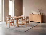 Dining room with wooden table and chairs in a modern interior setting.