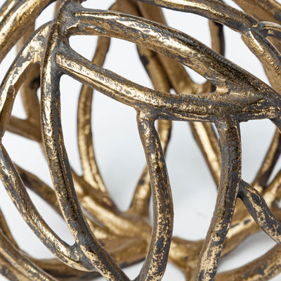 A decorative tree branch-shaped metal orb with a rustic gold tone finish.
