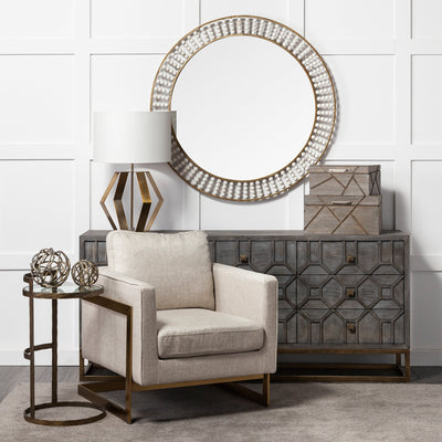 A decorative tree branch-shaped metal orb with a rustic gold tone finish.