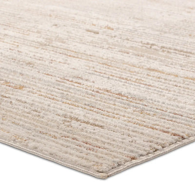 A power loomed area rug with beige and brown tones.