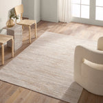 A power loomed area rug with beige and brown tones.