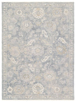 Floral patterned rug with light blue and beige colors on a white background
