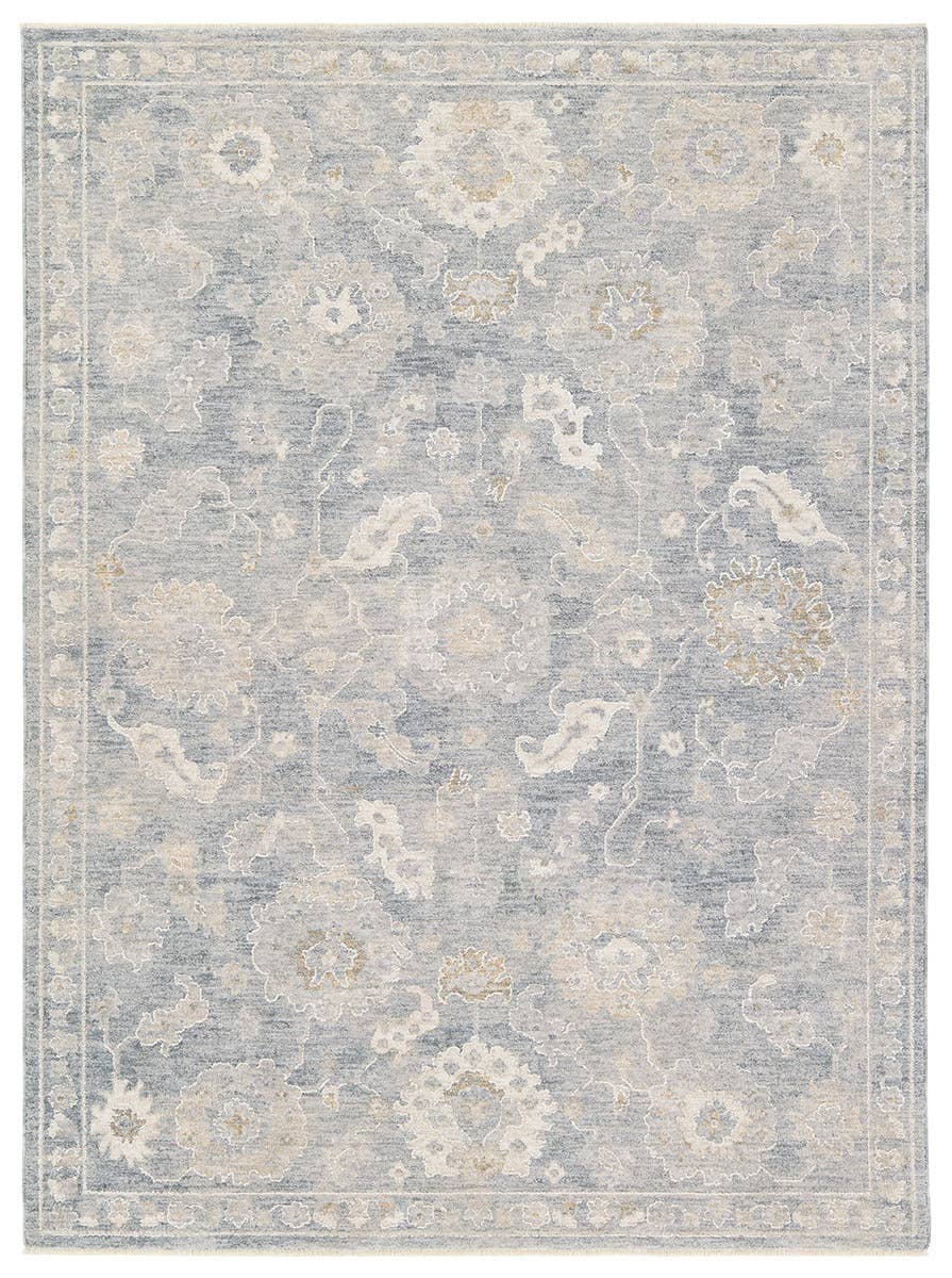 Floral patterned rug with light blue and beige colors on a white background
