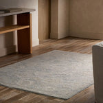 Hexagonal rug on a wooden floor with a wooden shelf and beige wall in the background