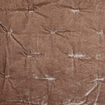 Brown textured fabric with visible folds