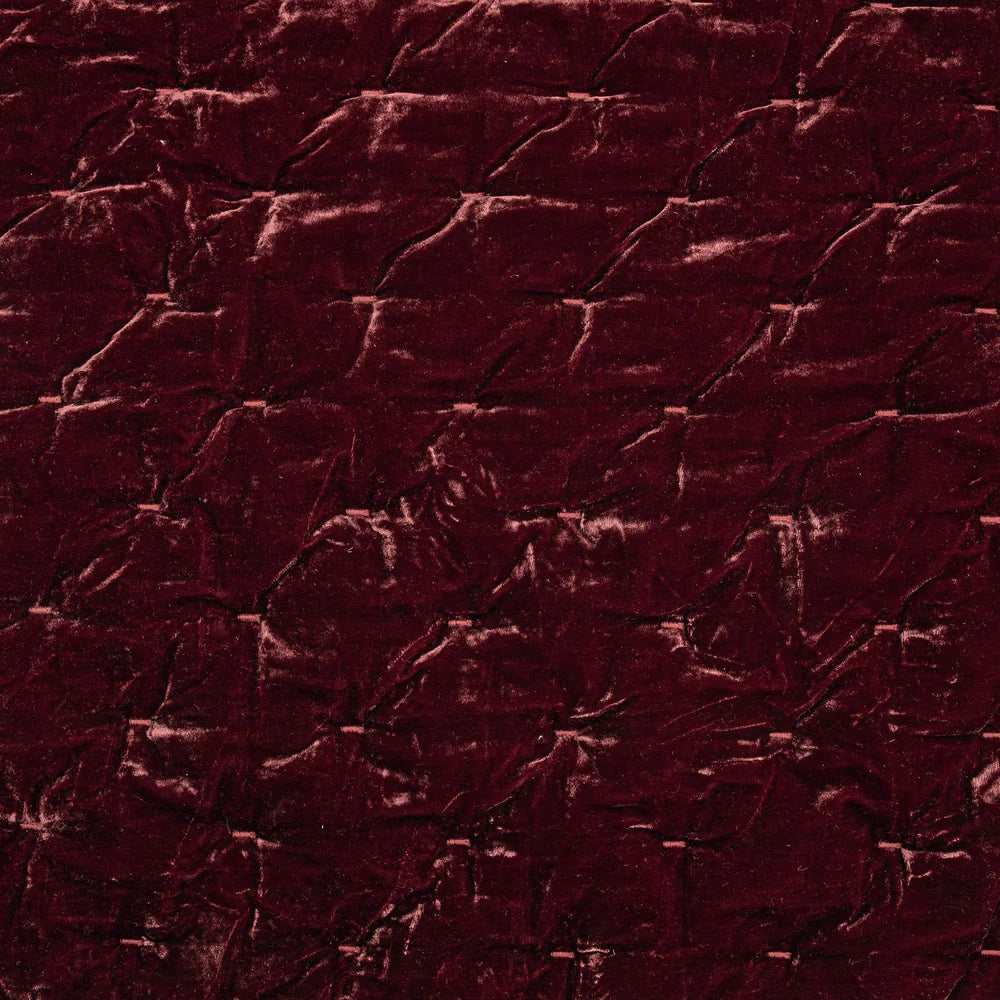 Close-up of a textured dark red fabric surface