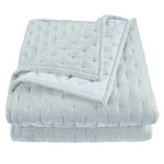 Folded light gray weighted blanket on a white background