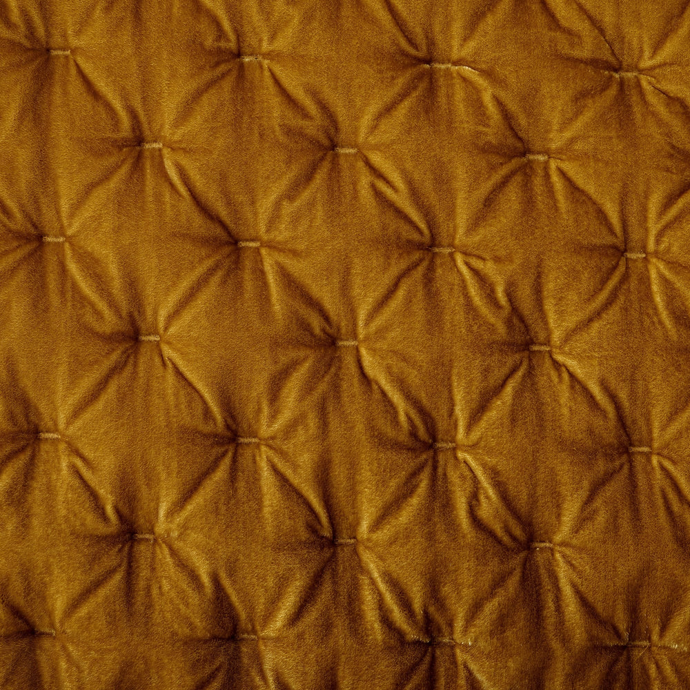 Close-up of a brown quilted fabric texture
