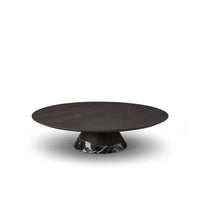 Round dark wooden table with a marble base on a white background