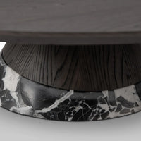 Round table with a dark wooden top and marble-patterned base on a white background