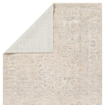 Close-up of a textured beige rug with subtle patterns on a white background