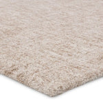 Close-up of a beige carpet with a textured pattern on a white background