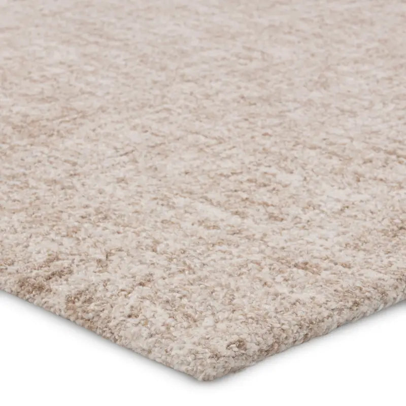 Close-up of a beige carpet with a textured pattern on a white background