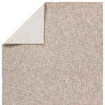 Textured beige rug corner with a white border