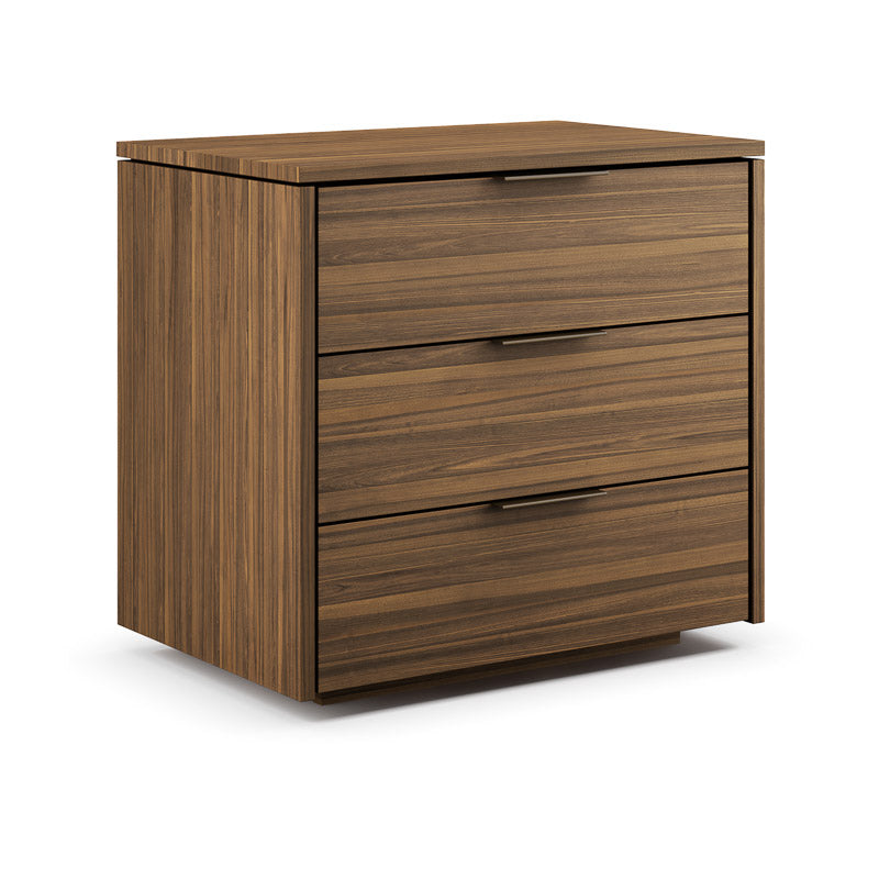 A brown wooden nightstand with three drawers, the closes drawer at the top, open midsized drawer in the middle, and an open largest drawer at the bottom.