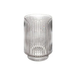 Clear glass vase with ribbed design on a white background
