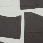 A black and white abstract wall art piece with geometric elements, framed in a black frame.