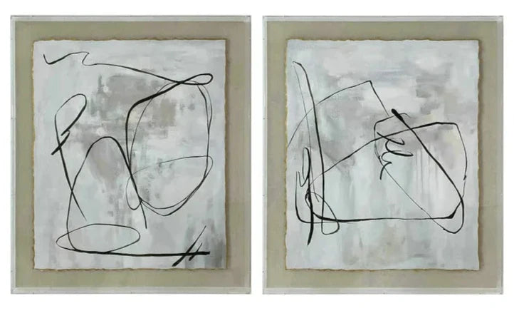 Two abstract wall art pieces with black line designs on a light background