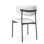 A white dining chair with a full backrest and seat, featuring a black metal frame.