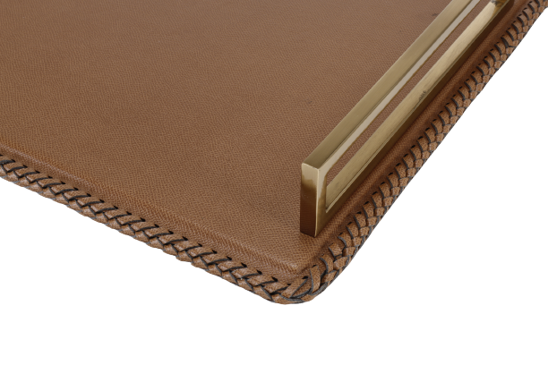 A leather tray with gold finished handle