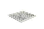 A white ivory serving tray with a geometric pattern.