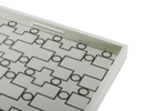 A white ivory serving tray with a geometric pattern.