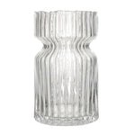 Clear glass vase with wavy design on a white background