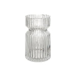Clear glass vase with ribbed design on a white background