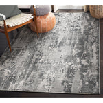 Gray patterned rug in a room with furniture